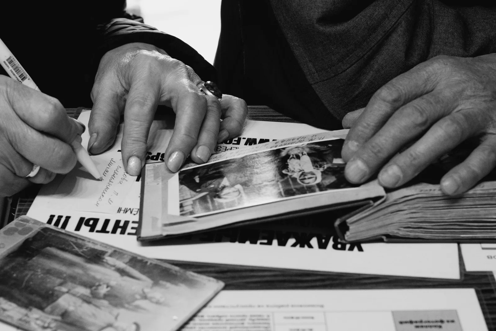 Manos de dos personas mayores revisando fotografías